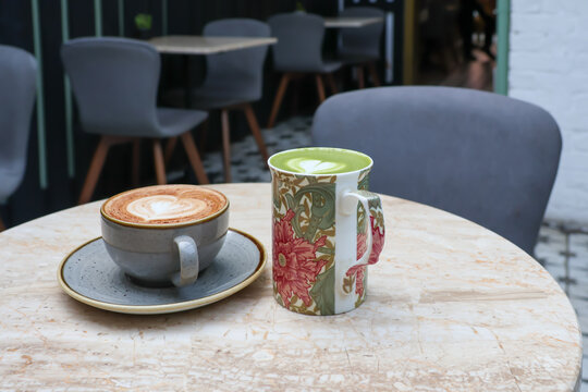 Two coffee cups in a cafe