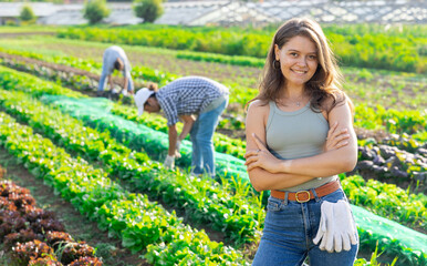 Girl is resting on garden field during work on harvesting from packaging of crop. Subsidiary farm,...