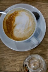 Cup of coffee on wooden background. Close up. View from the top