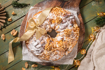 Bolo Rainha, a celebratory ring cake garnished with almonds, nuts, dried fruits, fruits raisins and...