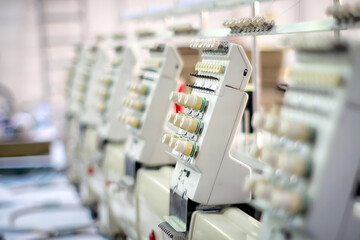 Industrial embroidery machines in action at a workshop