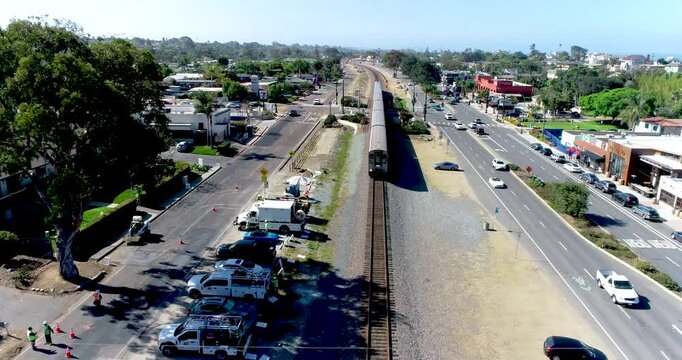 Aerial Path Along Train Tracks as Train Travels Below.