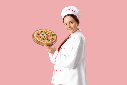 Female chef with tasty pizza on pink background