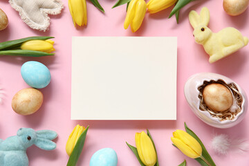 Composition with tulips, blank card and Easter eggs on pink background