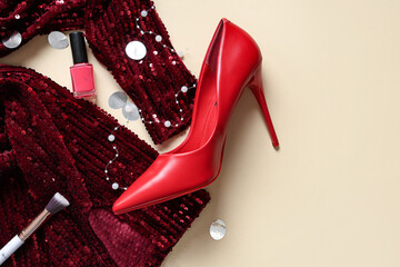 Prom dress with high heel shoe, nail polish and makeup brush on beige background