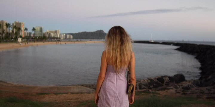 A woman watching volcano crater in hawaii, anamorphic lens