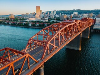 Fototapeta premium Aerial view of the Broadway Bridge over the Willamette River in Portland, OR. City skyline in the background. Golden hour light. Oregon, USA