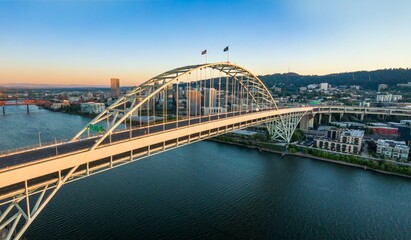 Aerial view of the Freemont Bridge over the Willamette River at sunset, Portland, OR. City skyline and modern architecture are visible. , Oregon, USA