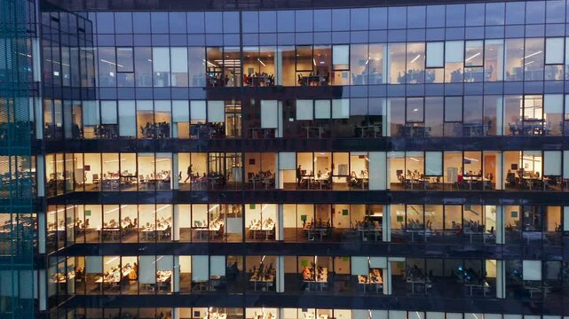 Aerial Footage Of Office Windows In A Modern Skyscraper At Night In Gdansk Business District. The Lights From The Offices Illustrate The Professional Vibe Of This Thriving Polish City.