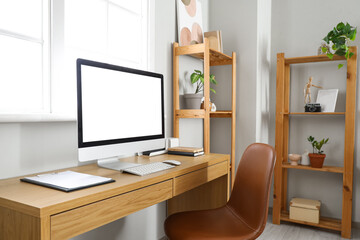 Programmer's workplace with computer and devices in living room
