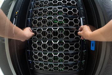 Hands Operating Server Rack with Hexagonal Grids and Cables