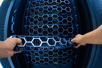 Hands Removing Server Tray from High-Tech Data Center Rack