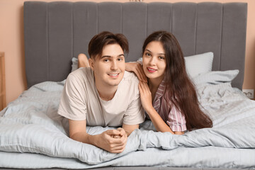 Young couple lying together in bed