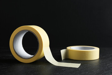 Rolls of masking tape on black table