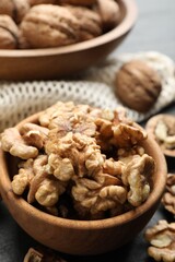 Fresh ripe walnuts in bowl on table, closeup