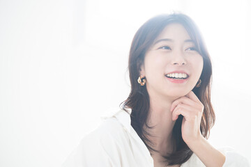 Close-up portrait of a fashionable woman with earrings in backlight