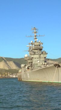 Big Russian military ship in port. Vertical video of a Russian port.