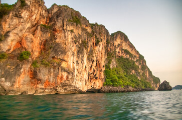 Long-tail boats silhouetted against a stunning sunset at Nui Beach, Phi Phi Don