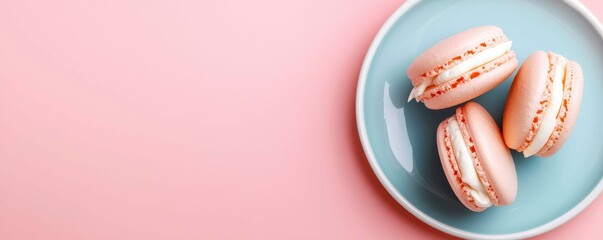 Fototapeta premium Pastel Pink Macarons on a Light Blue Plate Creating an Aesthetic Sweet and Colorful Composition