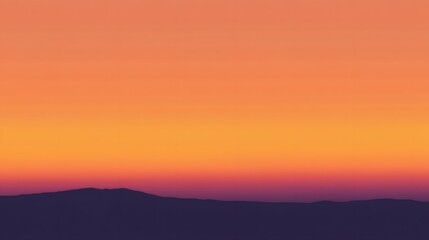 Obraz premium A vibrant sunset illuminates the sky above distant mountain silhouettes