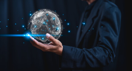 A person holds a glowing, digital globe in one hand, symbolizing technology, connectivity, and the...