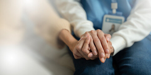 Helping hands,care for the elderly concept.Friendly Nurse or caregiver consoling senior woman...