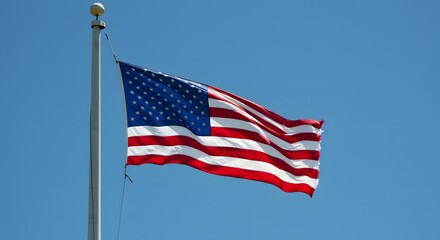 Obraz premium American Flag Waving Proudly Under a Clear Blue Sky