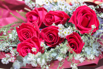 Red rose flower bouquet decorative with white gypsophila on background