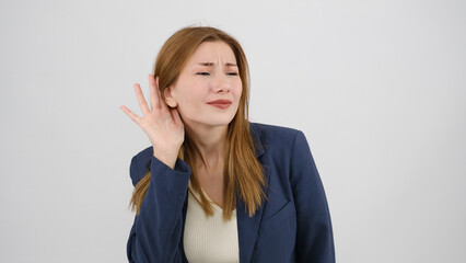 In a studio setting, a young businesswoman  s standing in front of a white background, placing her...