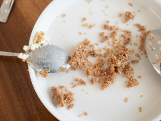 Sweet scraps on plates and spoon after a delicious sweet in a cafe.