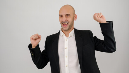 In a studio setting, a middle-aged businessman wearing a suit is dancing and looking at the camera in front of a white background