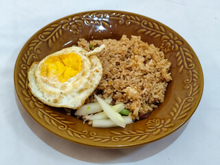 Fried rice, vegetables, crackers with fried egg as a side dish. Fried rice on a glass plate.