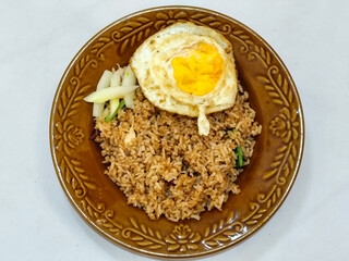 Fried rice, vegetables, crackers with fried egg as a side dish. Fried rice on a glass plate.