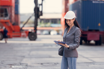 Portrait of young businesswomen survey the area to plan the storage and moving of goods in and out of the container storage area