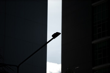 Silhouette of Street Lamp Against Modern Building Architecture
