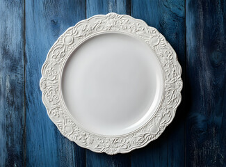 Elegant White Plate with Ornate Design on Distressed Blue Wood, Top-Down View, Inviting Culinary Presentation, Clean Aesthetic, Stylish Food Photography