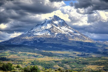 Majestic Snow-Capped Mountain Peak under Dramatic Cloudscape