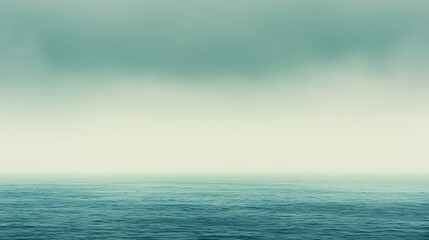 Obraz premium The calm ocean merges seamlessly with a cloudy pale sky
