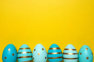 Empty yellow background with Easter eggs