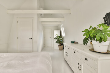 A serene minimalist interior featuring white walls, natural light, and indoor plants creating a calming atmosphere. Perfect for modern home design inspiration.