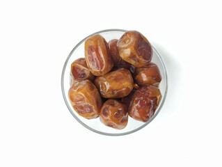 Date fruits in bowl isolated on white background, Typical Muslim food during the month of Ramadan 
