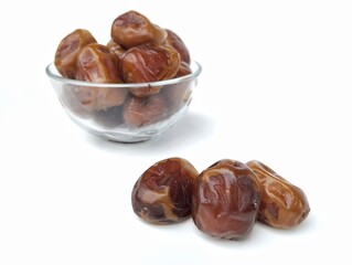 Date fruits in bowl isolated on white background, Typical Muslim food during the month of Ramadan 
