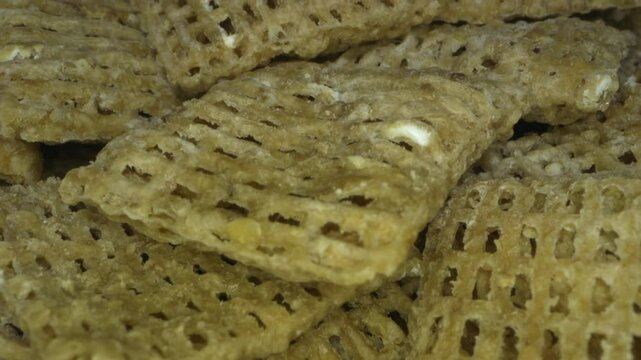 Toasted wheat-squares cereal. Probe lens macro. Extreme closeup.