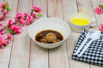 Egg and Pork in Sweet Brown Sauce(Khai Palo)Egg on top wood, stewed eggs in brown sauce by Thai food