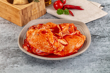 Raw chicken marinated thighs with skin