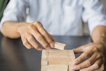 Planning risk and strategy in businessman gambling placing wooden block.Business concept for growth success process.