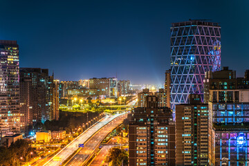 The charm of the interplay of light and shadow among the tall buildings in the night view of the...