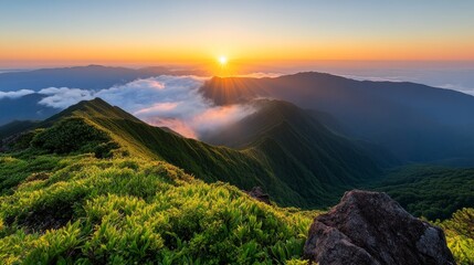 Majestic Sunrise Over Serene Mountain Range Bathed in Golden Light with Clouds Rolling in the Valley Below