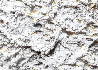 The image is a white and grey wall with a textured surface