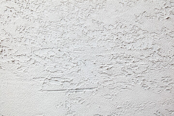 The wall is white and has a rough texture